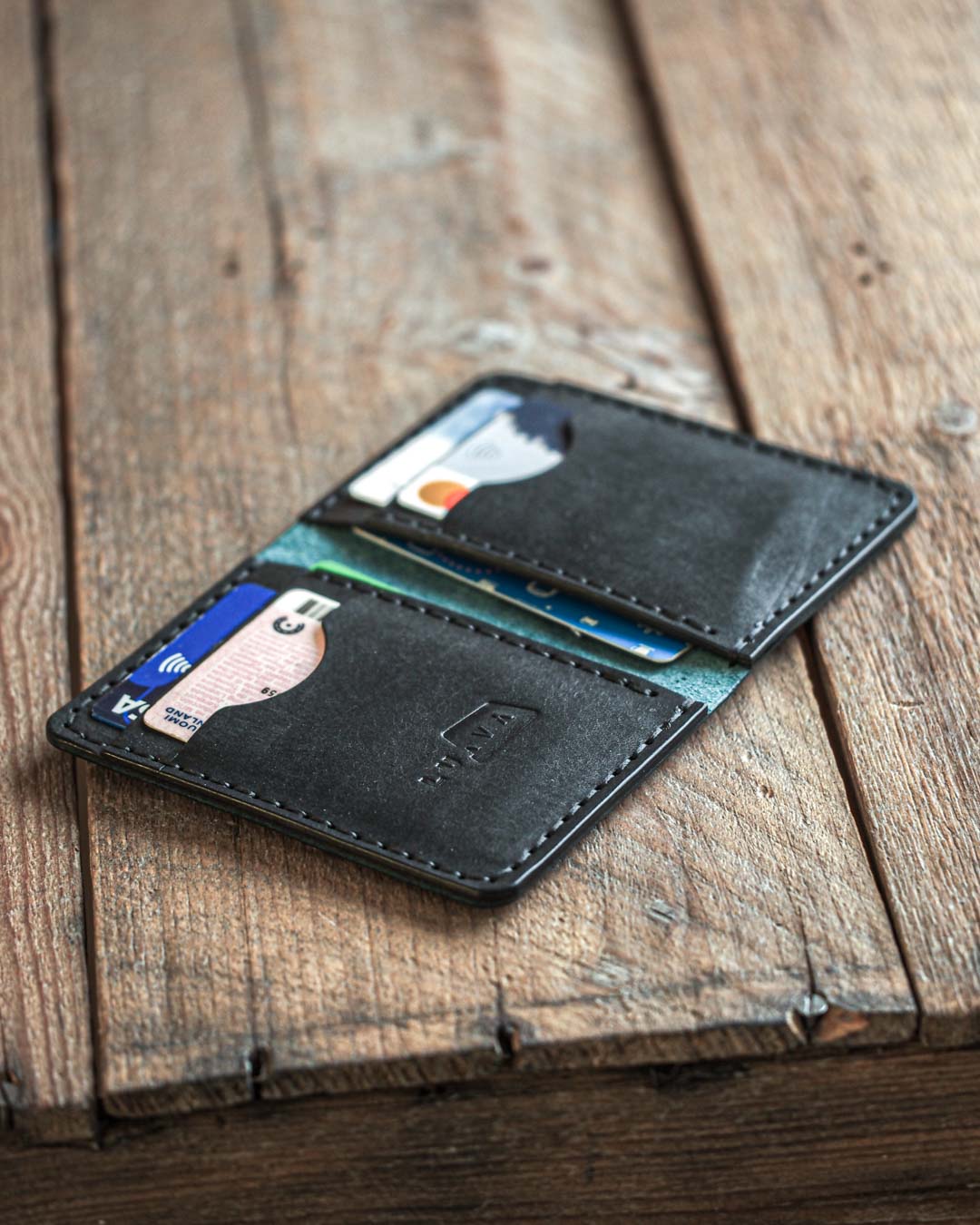 Luava handmade leather bi-fold wallet for men ranch open in use. Mens wallet.